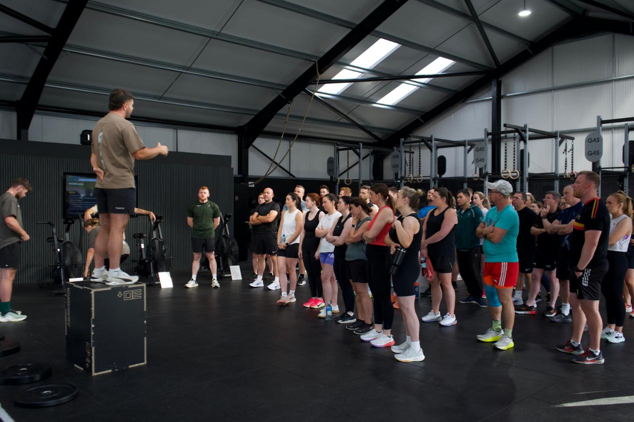 A G45 coach briefing a full class inside the gym on Ballynakilly Road