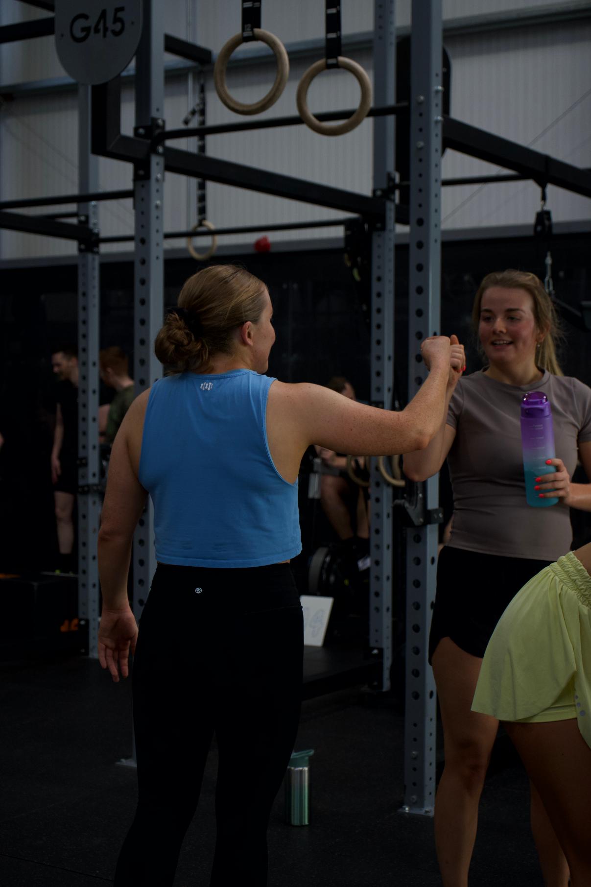 Two members high fiving at the end of a session